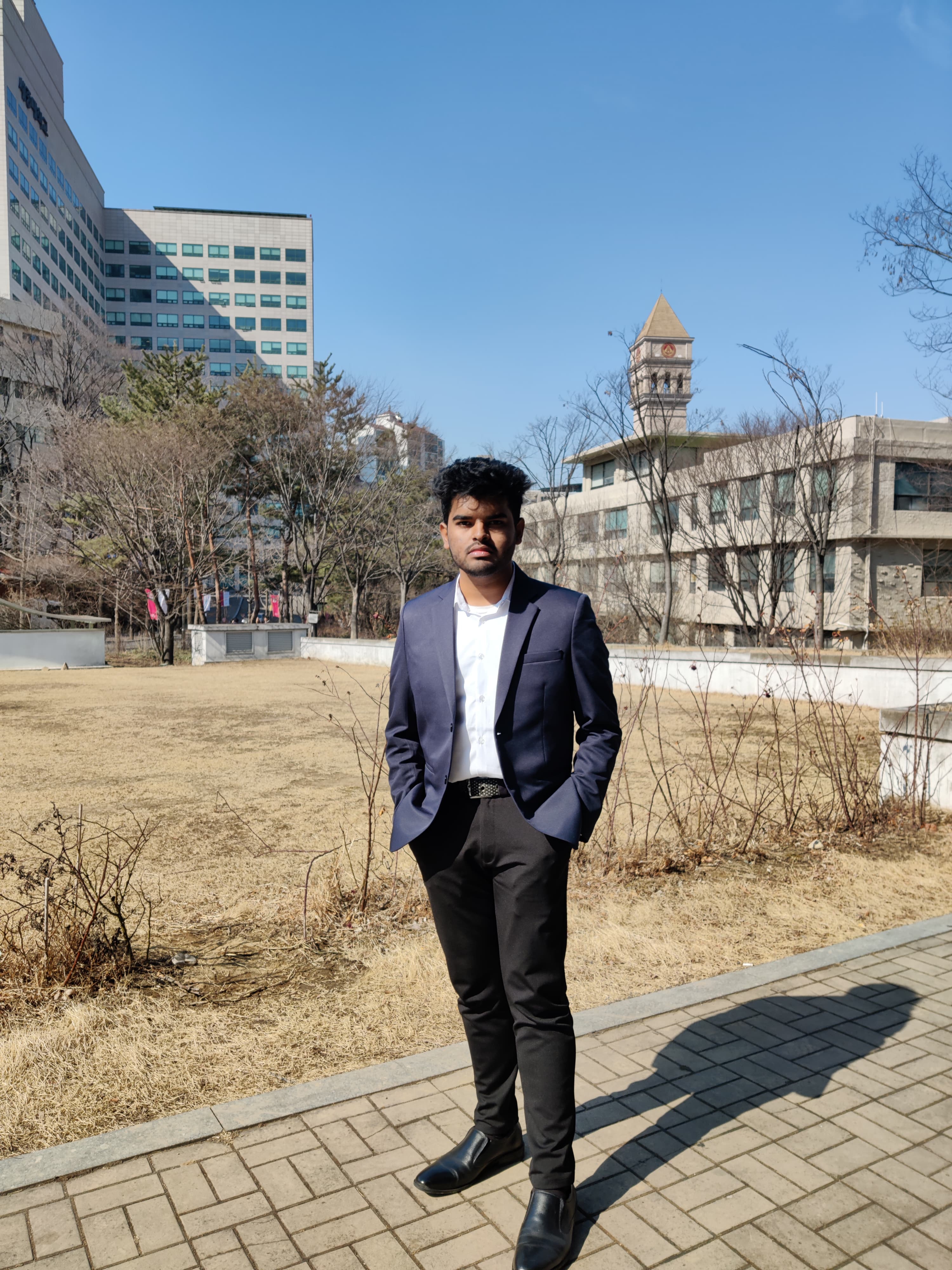 Shawkat Hossain Maruf on his Computer Science and Engineering orientation day at Sejong University, standing in front of the student union building.
